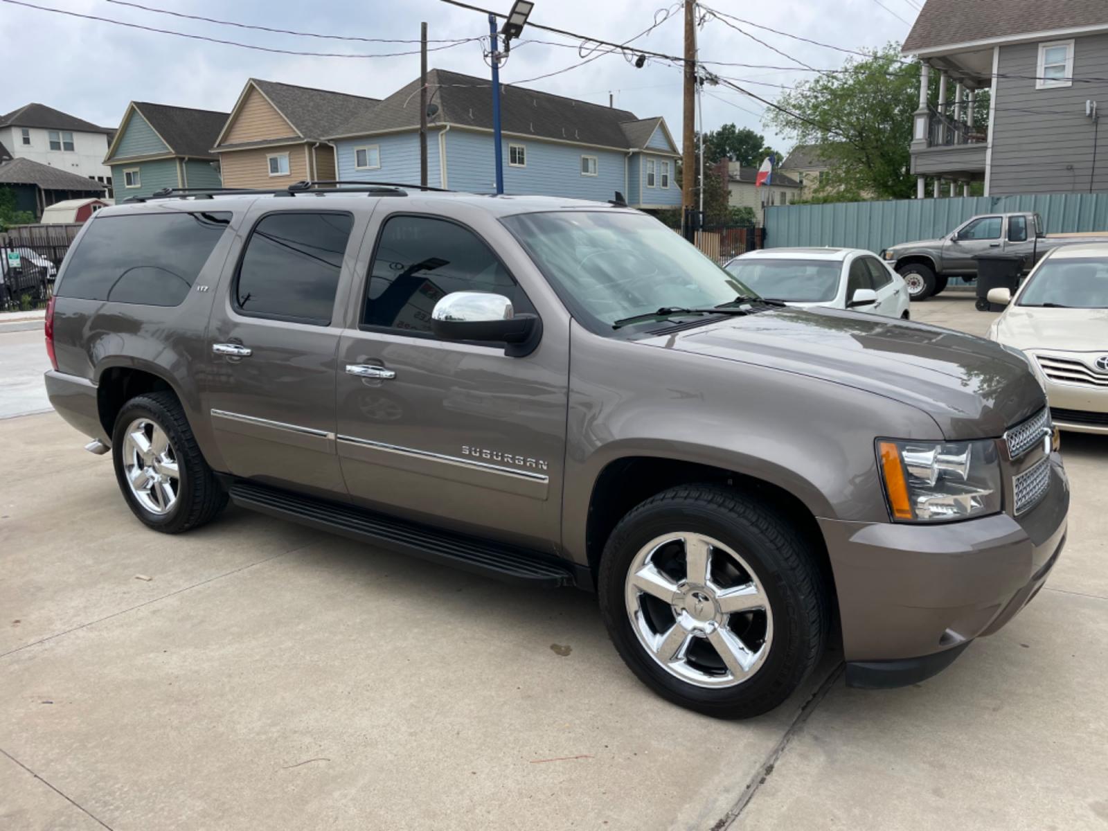 2014 Brown /Beige Chevrolet Suburban LTZ (1GNSCKE04ER) with an 5.3L V8 OHV 16V FFV engine, 6-Speed Automatic transmission, located at 1501 West 15th St., Houston, 77008, (713) 869-2925, 29.797941, -95.411789 - Photo #1