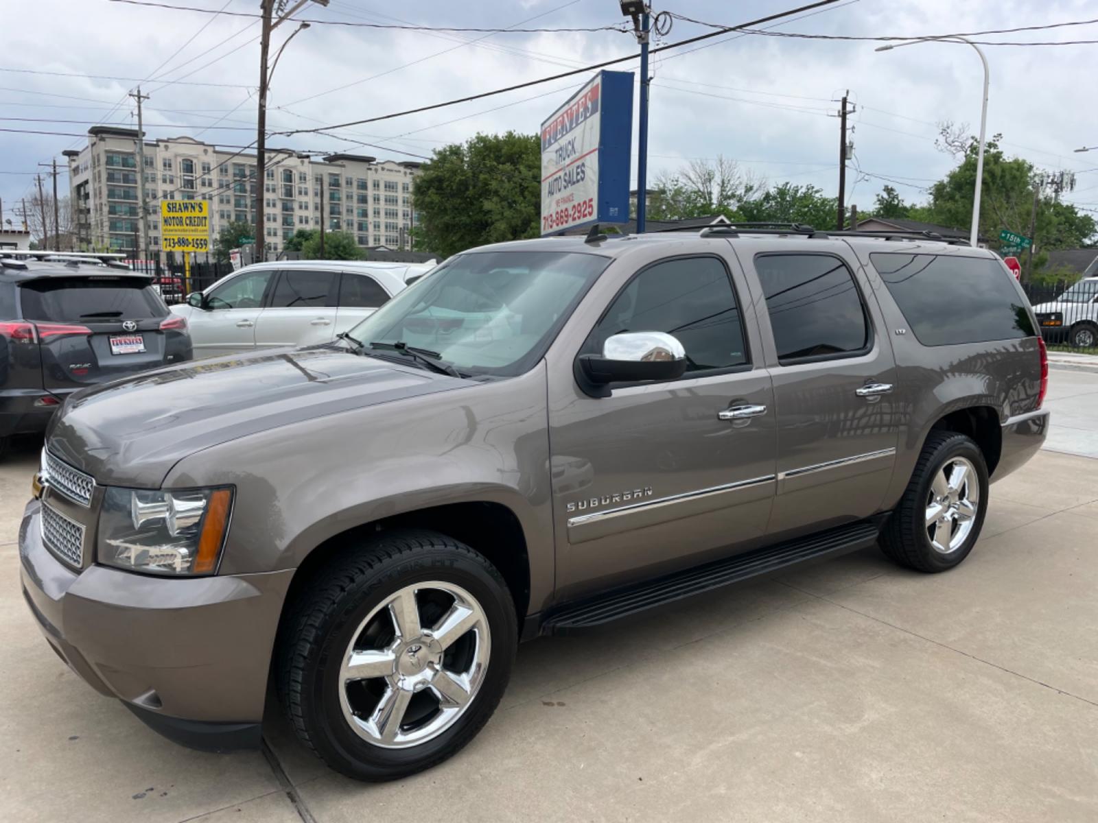 2014 Brown /Beige Chevrolet Suburban LTZ (1GNSCKE04ER) with an 5.3L V8 OHV 16V FFV engine, 6-Speed Automatic transmission, located at 1501 West 15th St., Houston, 77008, (713) 869-2925, 29.797941, -95.411789 - Photo #0