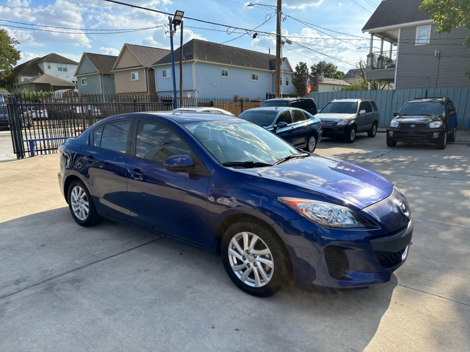 2012 Blue /Beige Mazda MAZDA3 i Touring 4-Door (JM1BL1VF1C1) with an 2.0L L4 DOHC 16V engine, Auto transmission, located at 1501 West 15th St., Houston, 77008, (713) 869-2925, 29.797941, -95.411789 - Photo #1