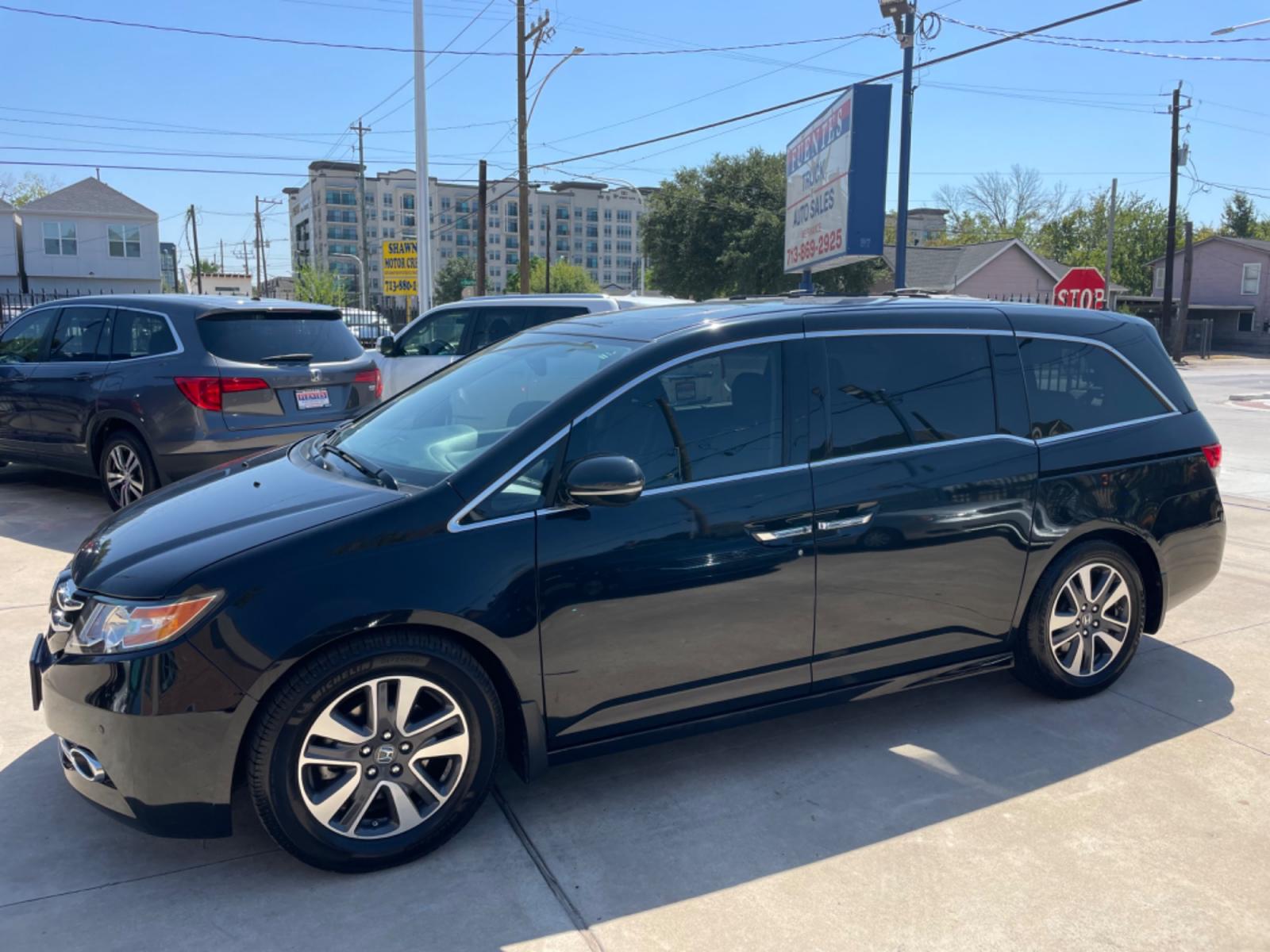 2015 Black /Gray Honda Odyssey Touring (5FNRL5H96FB) with an 3.5L V6 SOHC 24V engine, 6-Speed Automatic transmission, located at 1501 West 15th St., Houston, 77008, (713) 869-2925, 29.797941, -95.411789 - Photo #0
