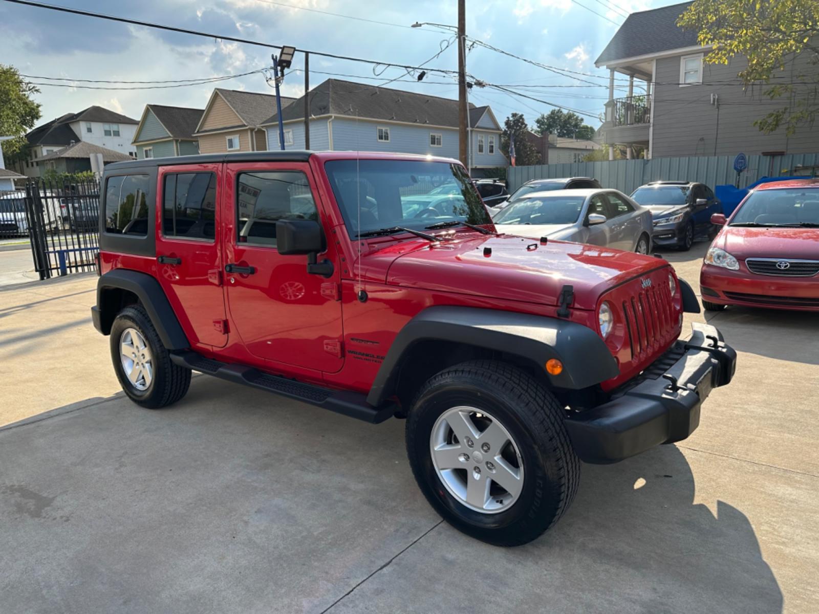 2014 Red /Black Jeep Wrangler Unlimited Sport 4WD (1C4HJWDG7EL) with an 3.6L V6 DOHC 24V FFV engine, Automatic transmission, located at 1501 West 15th St., Houston, 77008, (713) 869-2925, 29.797941, -95.411789 - Photo #1