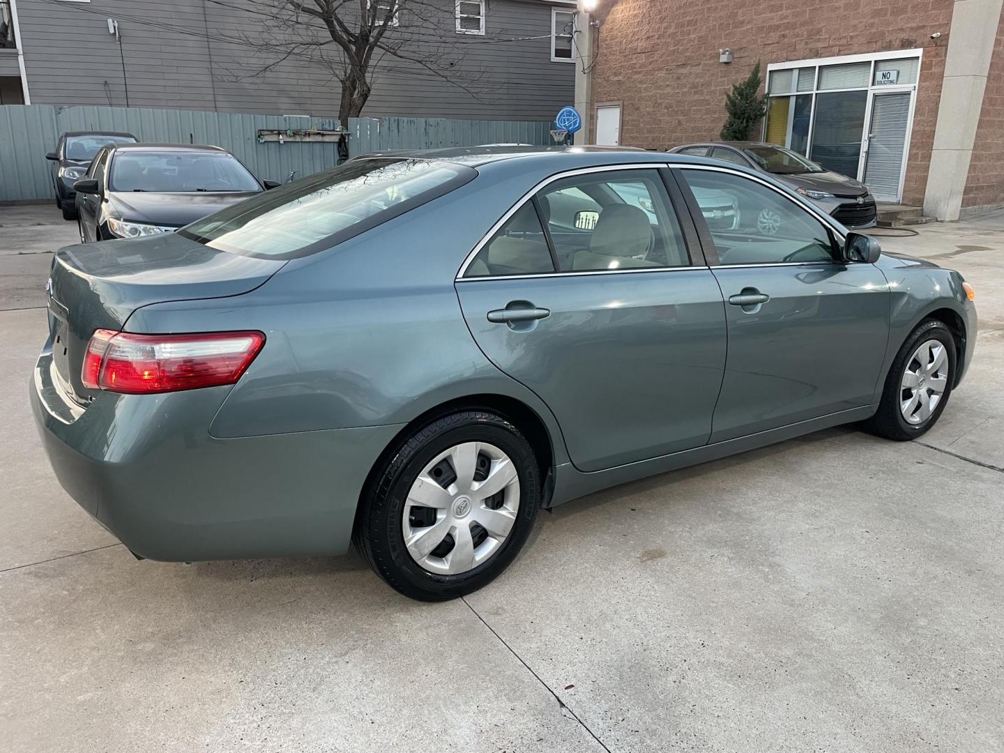 2009 Green /Beige Toyota Camry CE 5-Spd AT (4T4BE46K99R) with an 2.4L L4 DOHC 16V engine, 5-Speed Automatic Overdrive transmission, located at 1501 West 15th St., Houston, 77008, (713) 869-2925, 29.797941, -95.411789 - Photo#2