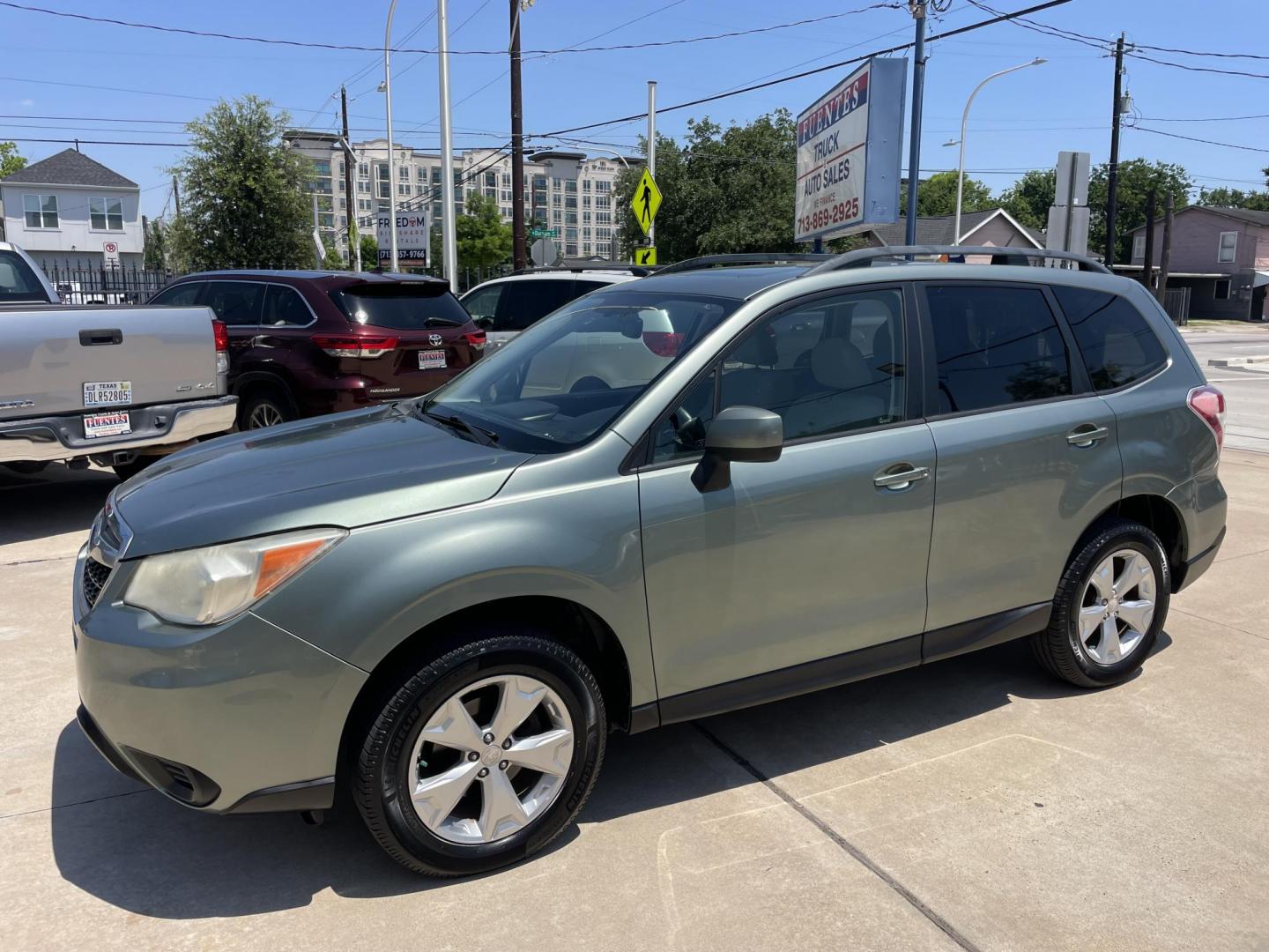 2014 Green /Silver Subaru Forester 2.5i Premium (JF2SJADC7EH) with an 2.5L H4 SOHC 16V engine, 6-Speed Automatic transmission, located at 1501 West 15th St., Houston, 77008, (713) 869-2925, 29.797941, -95.411789 - Photo#0