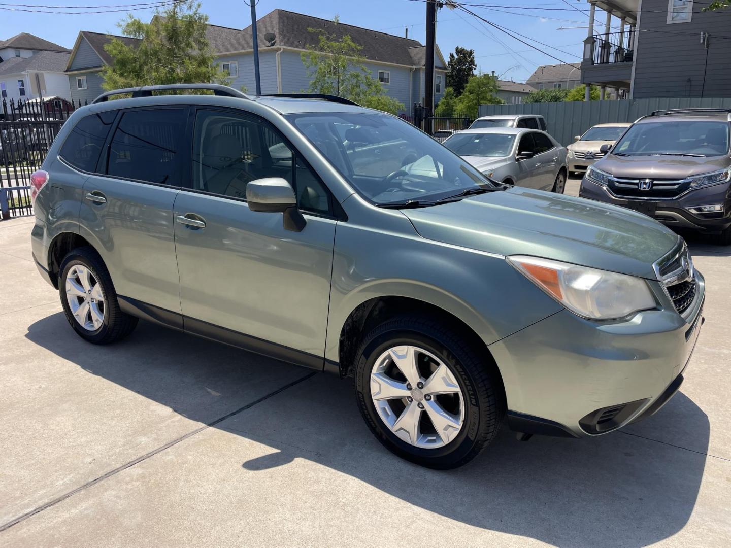 2014 Green /Silver Subaru Forester 2.5i Premium (JF2SJADC7EH) with an 2.5L H4 SOHC 16V engine, 6-Speed Automatic transmission, located at 1501 West 15th St., Houston, 77008, (713) 869-2925, 29.797941, -95.411789 - Photo#1