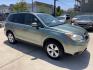 2014 Green /Silver Subaru Forester 2.5i Premium (JF2SJADC7EH) with an 2.5L H4 SOHC 16V engine, 6-Speed Automatic transmission, located at 1501 West 15th St., Houston, 77008, (713) 869-2925, 29.797941, -95.411789 - Photo#1