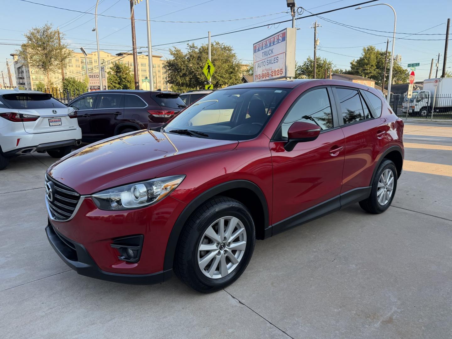 2016 Red /Black Mazda CX-5 Touring (JM3KE2CY5G0) with an 2.5L L4 DOHC 16V engine, 6A transmission, located at 1501 West 15th St., Houston, 77008, (713) 869-2925, 29.797941, -95.411789- Photo#0