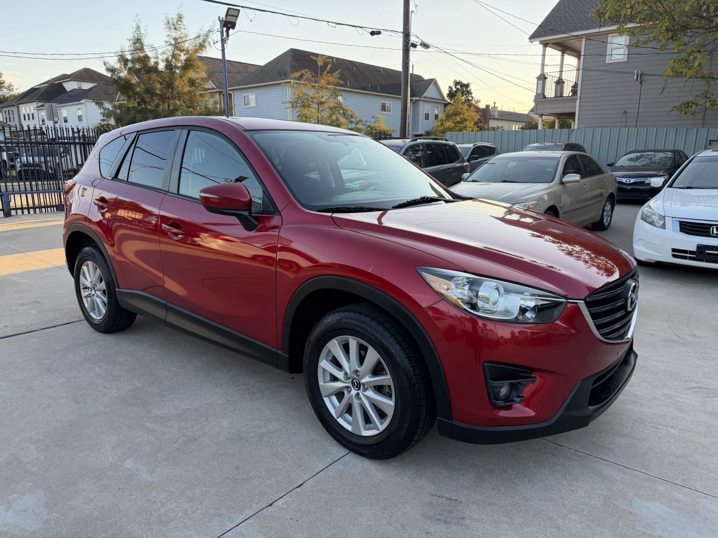 2016 Red /Black Mazda CX-5 Touring (JM3KE2CY5G0) with an 2.5L L4 DOHC 16V engine, 6A transmission, located at 1501 West 15th St., Houston, 77008, (713) 869-2925, 29.797941, -95.411789- Photo#2